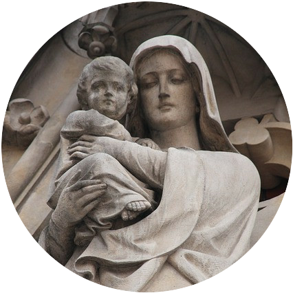 A old, gothic grey statue of Mary holding Christ