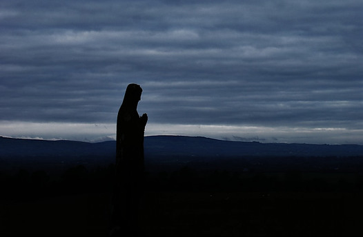 A statue of Mary in the evening
